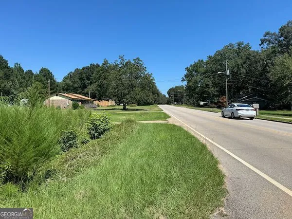 a view of street with houses and a trees