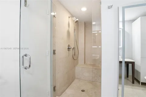 a bathroom with a shower and a shower