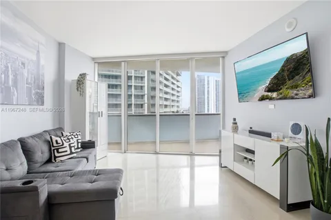 a living room with furniture and a painting on the wall