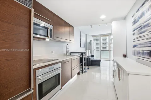 a kitchen with stainless steel appliances granite countertop a stove and a sink