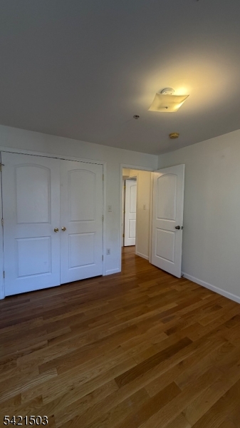 157 Lafayette Street, Unit 2 Newark, NJ 07105 - Photo 14 of 19 an empty room with wooden floor and cabinet