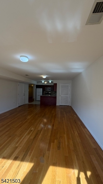 157 Lafayette Street, Unit 2 Newark, NJ 07105 - Photo 2 of 19 a view of empty room with wooden floor