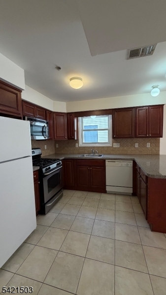 157 Lafayette Street, Unit 2 Newark, NJ 07105 - Photo 3 of 19 a kitchen with stainless steel appliances a refrigerator sink and cabinets