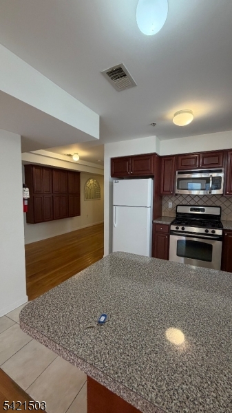 157 Lafayette Street, Unit 2 Newark, NJ 07105 - Photo 4 of 19 a kitchen with stainless steel appliances granite countertop a sink and a stove
