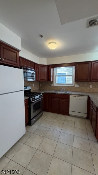 157 Lafayette Street, Unit 2 Newark, NJ 07105 - Photo 6 of 19 a kitchen with a cabinets and appliances