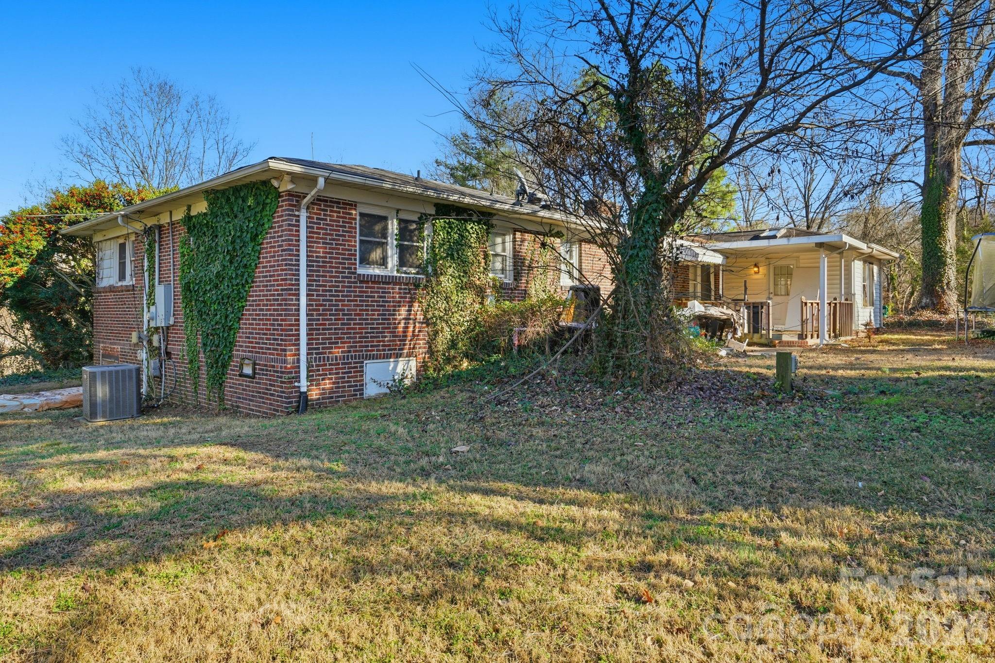 106 Fielding Road Charlotte, NC 28214 - Photo 4 of 10 a view of a yard in front of a house with large trees