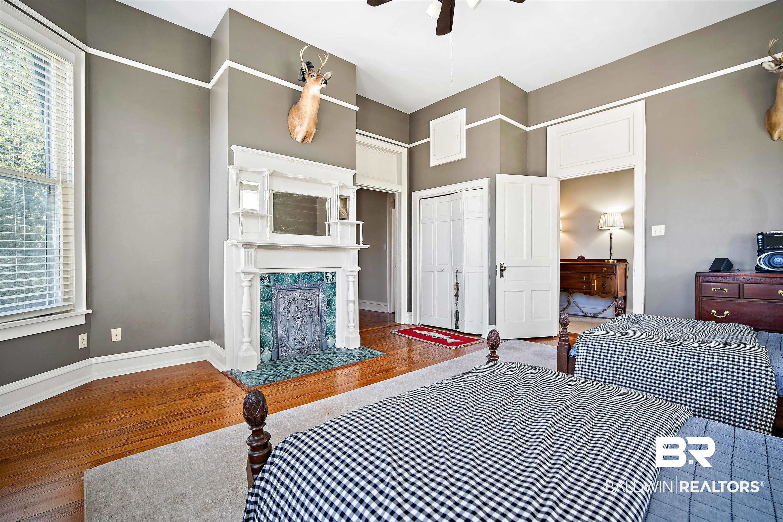1314 Dauphin Street Mobile, AL 36604 - Photo 40 of 61 Bedroom featuring a premium fireplace, ceiling fan, a closet, and hardwood flooring