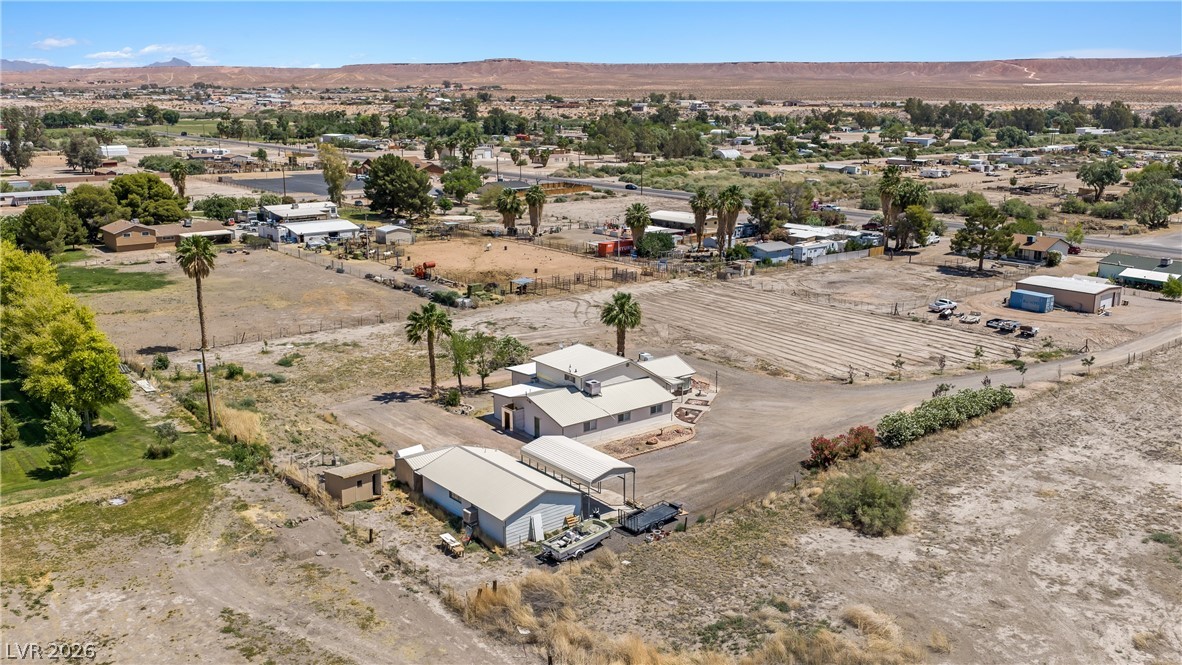 750 Leming Avenue Overton, NV 89040 - Photo 80 of 82 This expansive property features a main residence, additional outbuildings, and mature trees within a desert landscape.