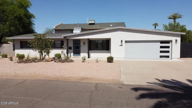 a view of a house with snow on the road
