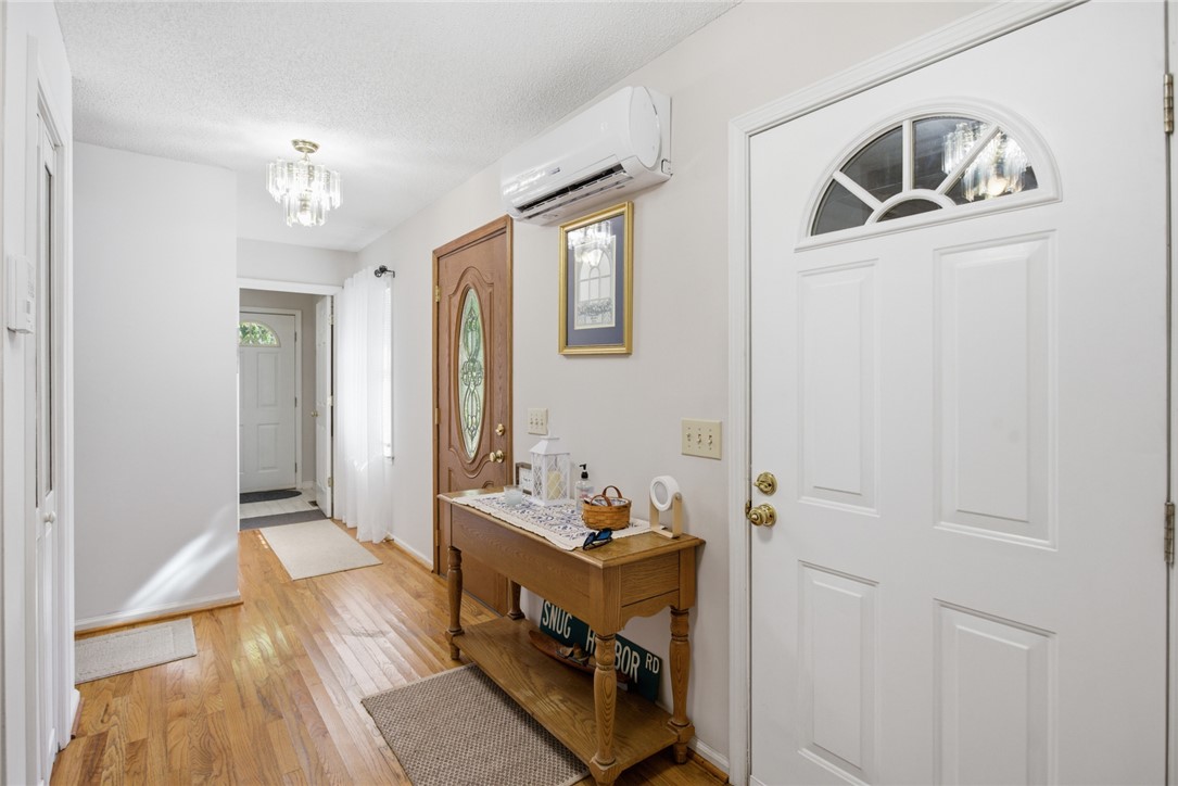 110 Snug Harbor Road Seneca, SC 29678 - Photo 4 of 37 Step into this welcoming entryway featuring warm hardwood floors and bright lighting.