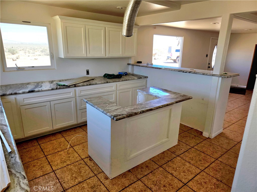 195 Old El Mirage Road Adelanto, CA 92301 - Photo 21 of 37 a kitchen with stainless steel appliances granite countertop a sink stove and cabinets