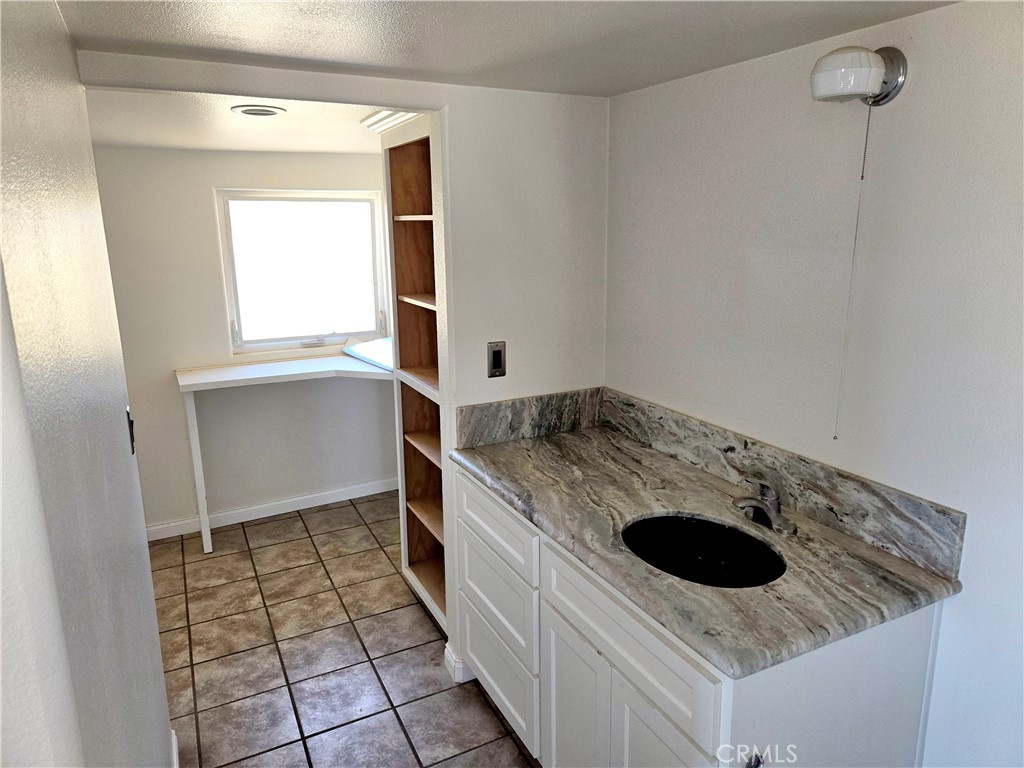 195 Old El Mirage Road Adelanto, CA 92301 - Photo 26 of 37 a kitchen with a stove sink and cabinets