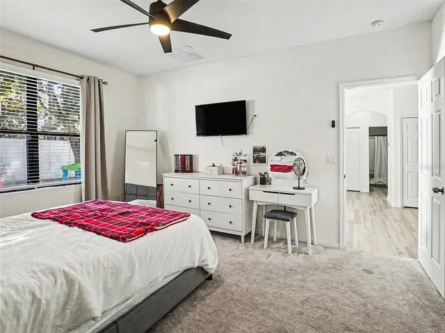 a bedroom with a bed and flat screen tv