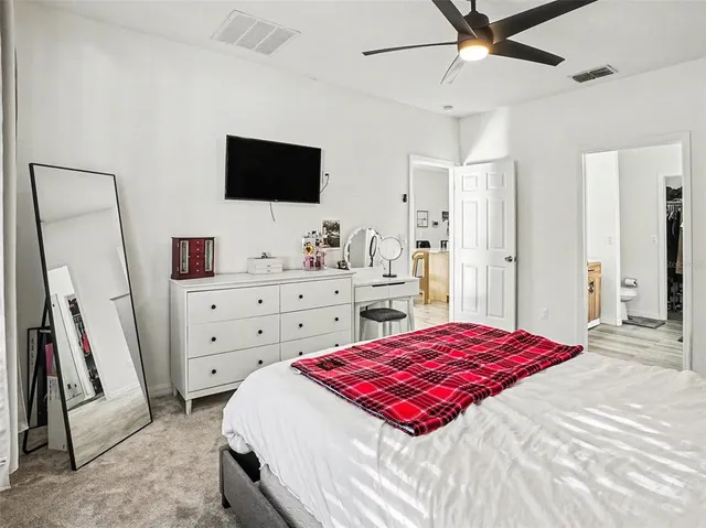a bedroom with a bed and a flat screen tv in it