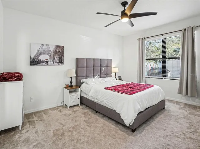a bedroom with a bed and a large window