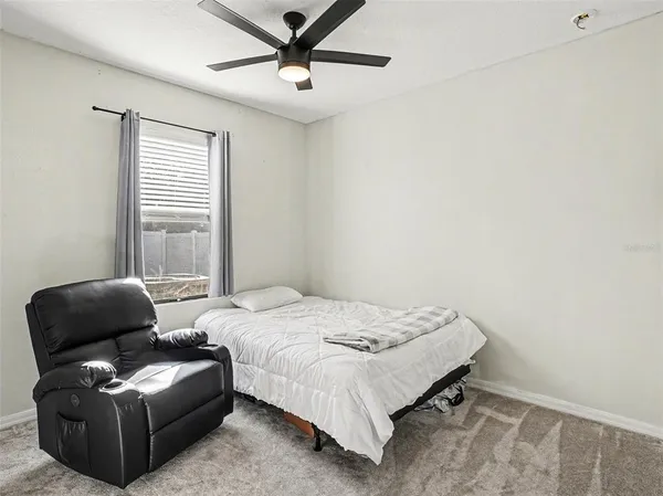 a bedroom with a bed and a couch