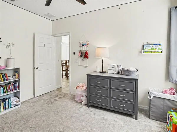 a bed room with a bed and a book shelf