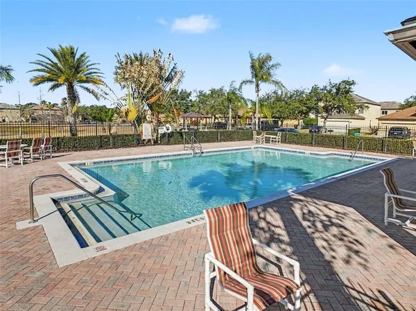 a view of a swimming pool with a lounge chairs