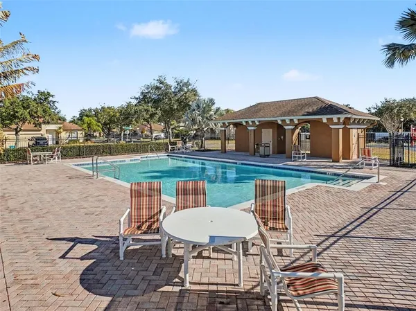 a view of a patio with table and chairs with wooden floor and fence