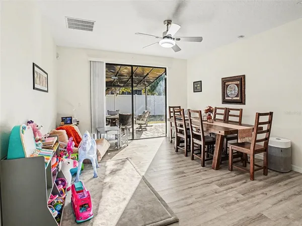 a view of a dining room with furniture floor to ceiling window