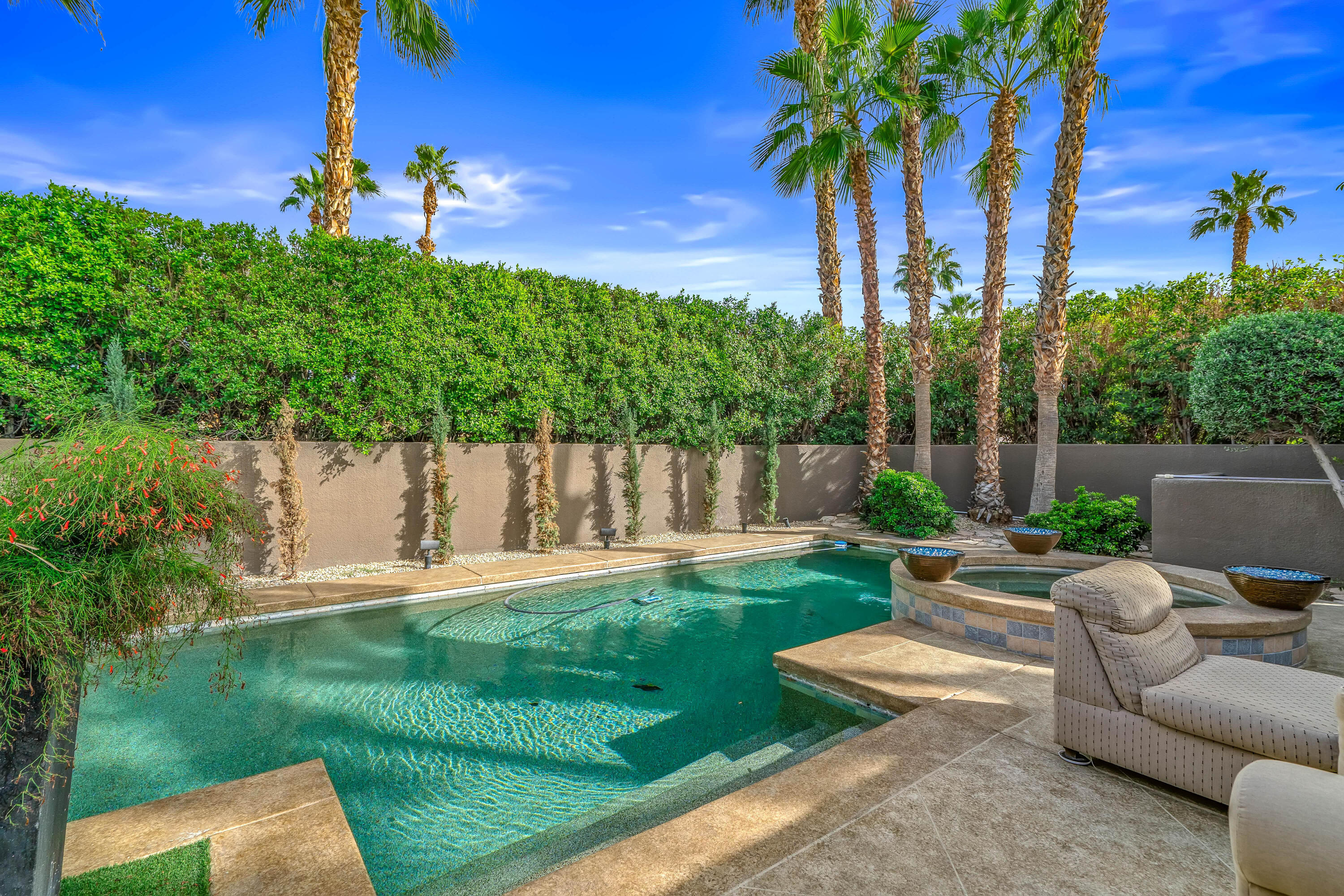 79200 Jack Rabbit Trail La Quinta, CA 92253 - Photo 12 of 76 a view of a backyard with couches plants and large tree