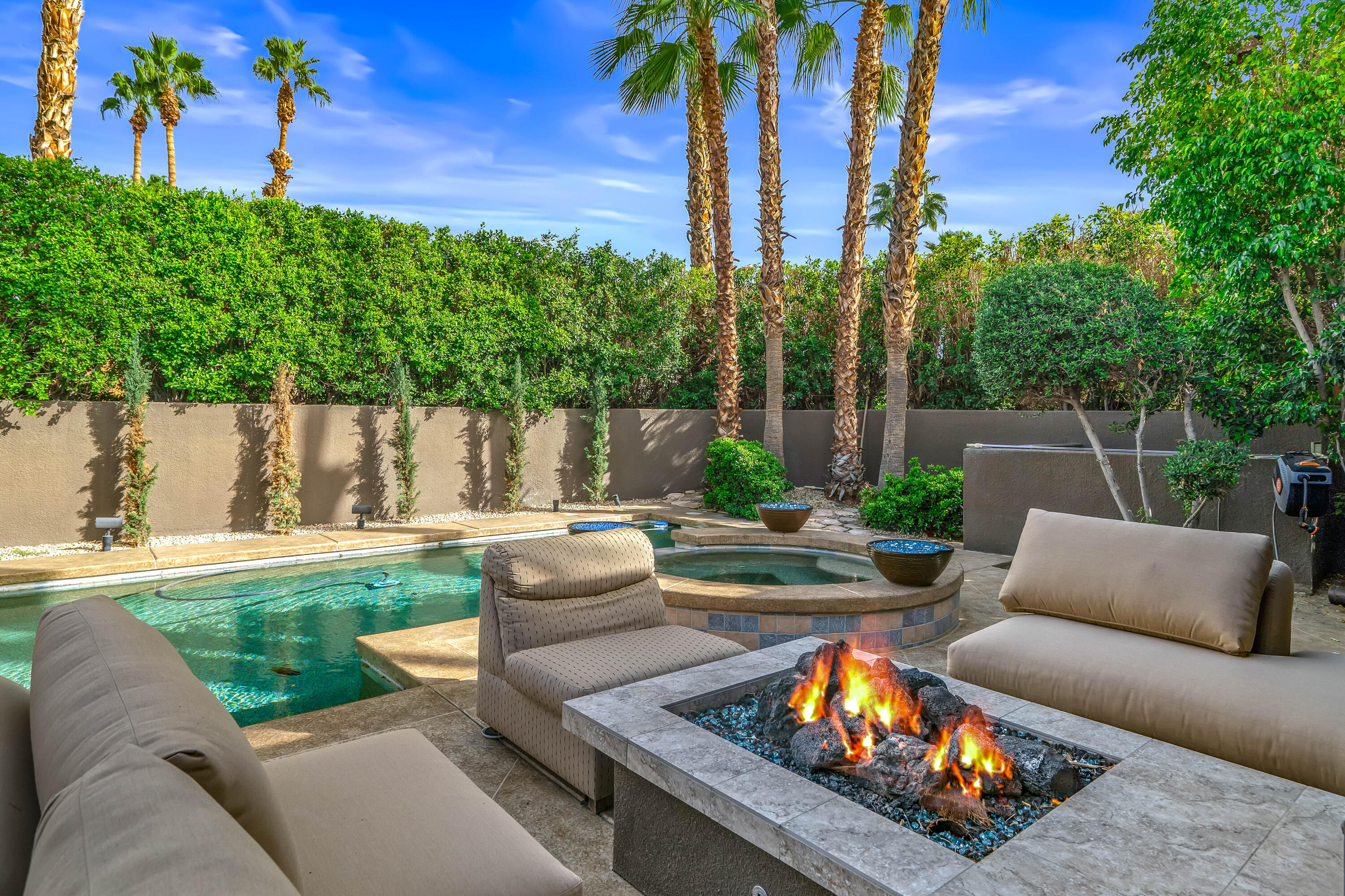 79200 Jack Rabbit Trail La Quinta, CA 92253 - Photo 15 of 76 a view of a backyard with couches potted plants and tree