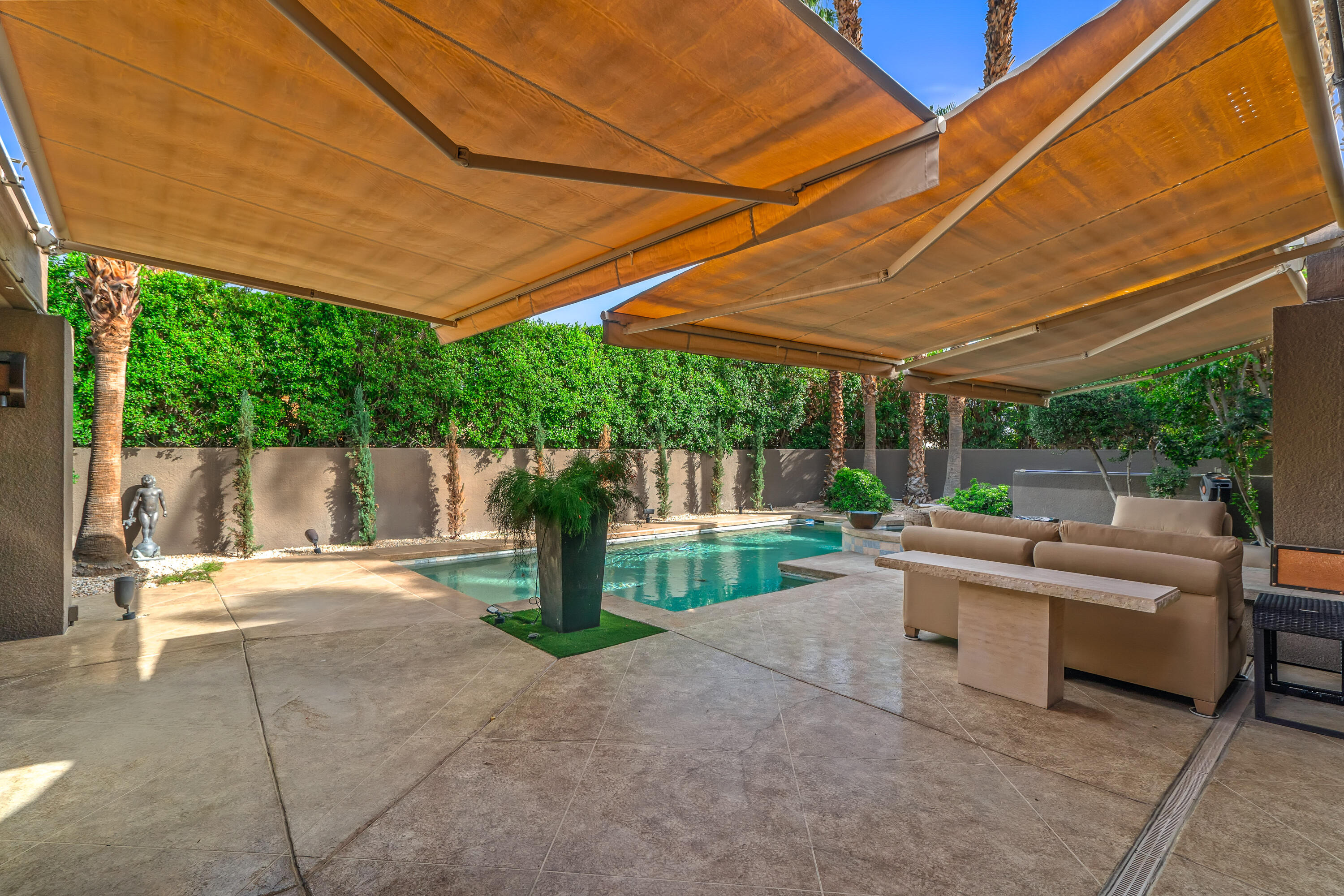 79200 Jack Rabbit Trail La Quinta, CA 92253 - Photo 16 of 76 a view of a patio with a table and chairs under an umbrella
