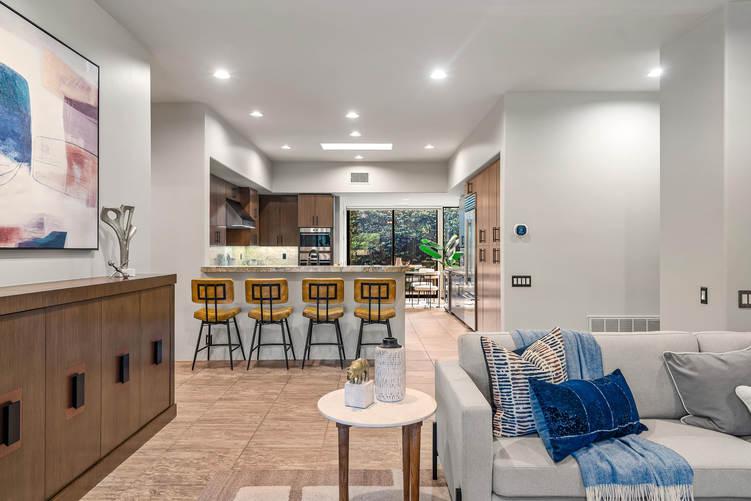 79200 Jack Rabbit Trail La Quinta, CA 92253 - Photo 32 of 76 a living room with furniture and a dining table with kitchen view