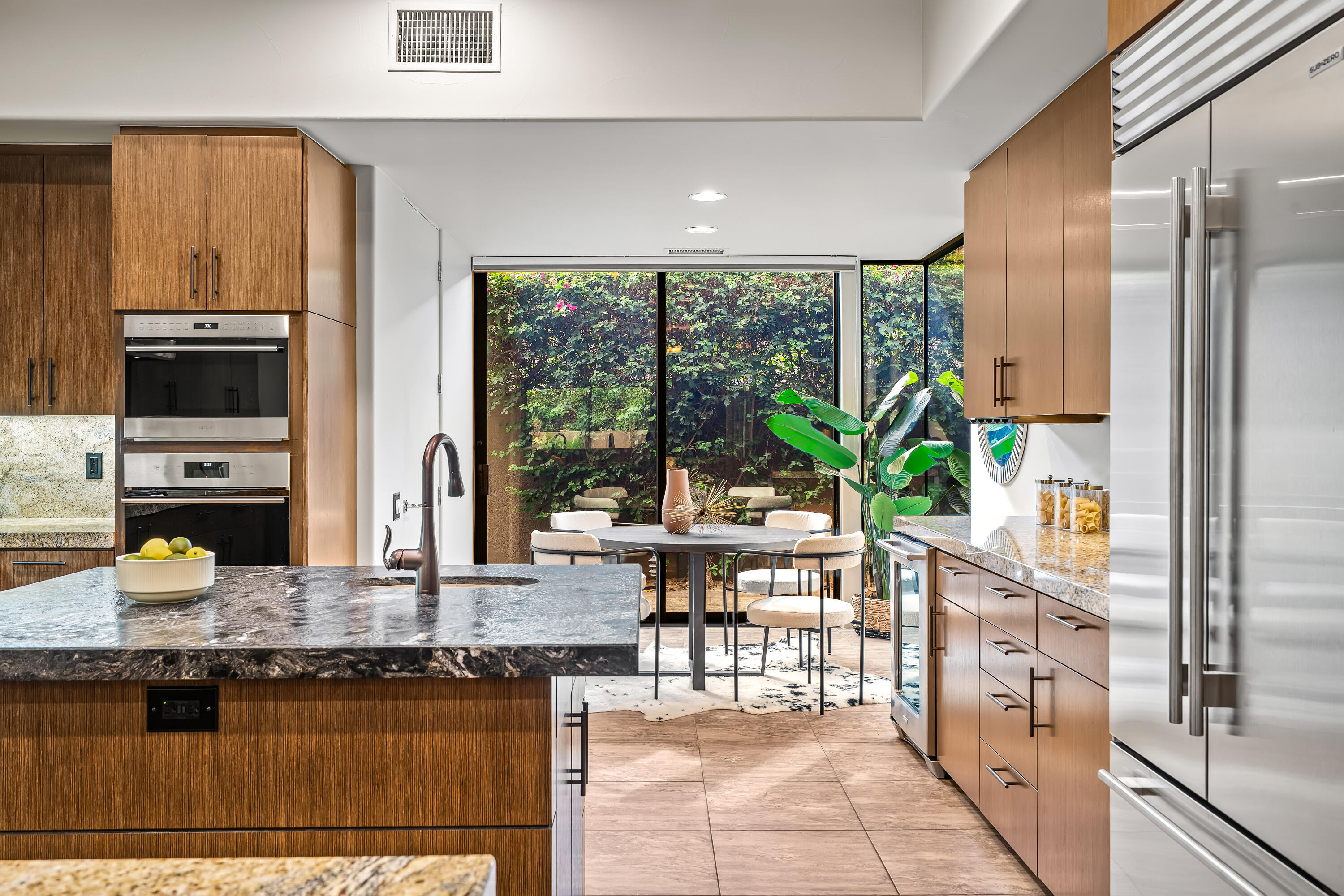 79200 Jack Rabbit Trail La Quinta, CA 92253 - Photo 35 of 76 a kitchen with stainless steel appliances granite countertop a stove a sink and a dining table