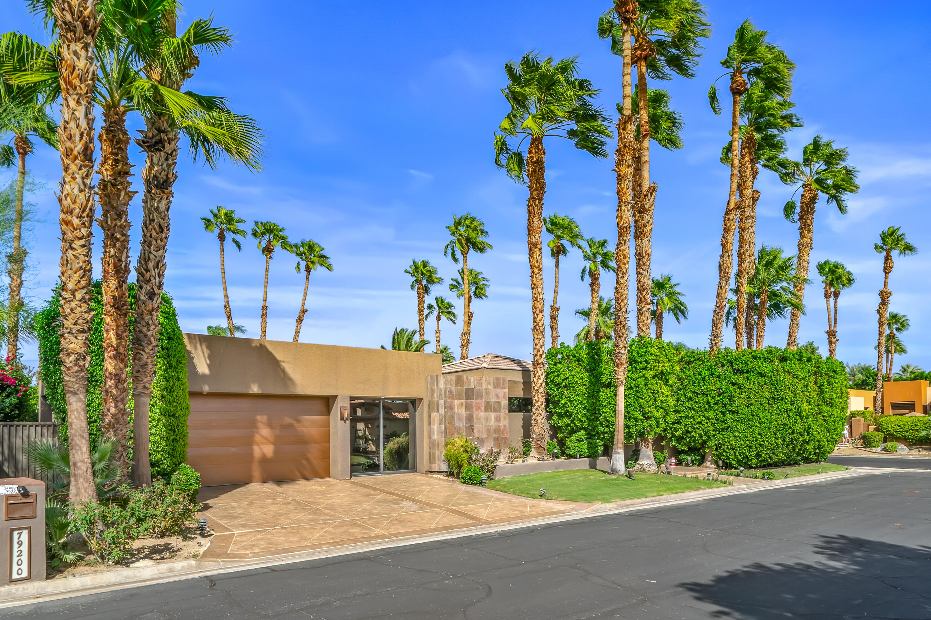 79200 Jack Rabbit Trail La Quinta, CA 92253 - Photo 4 of 76 a front view of a house with a yard and potted plants
