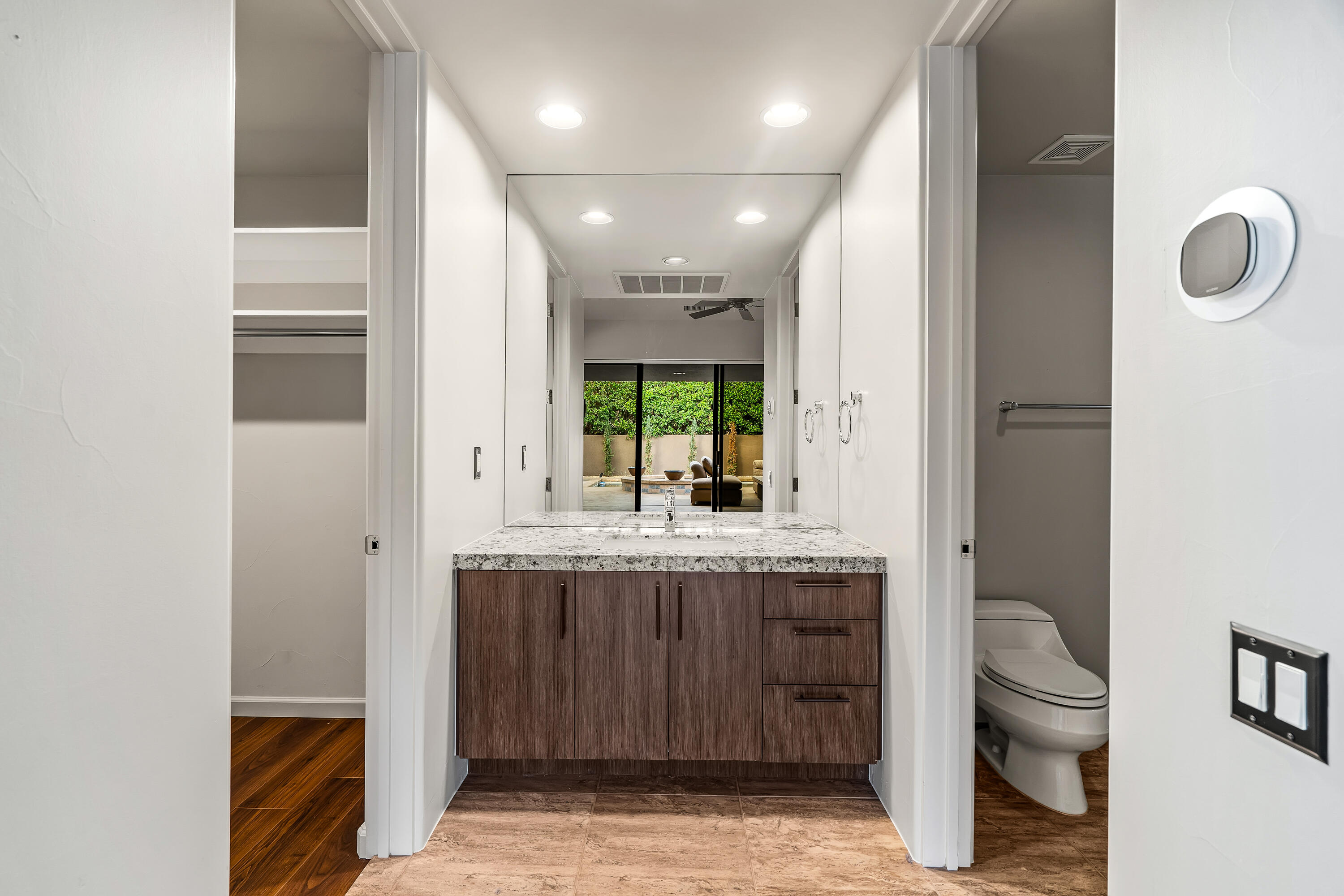 79200 Jack Rabbit Trail La Quinta, CA 92253 - Photo 64 of 76 a bathroom with a granite countertop sink a toilet and a mirror