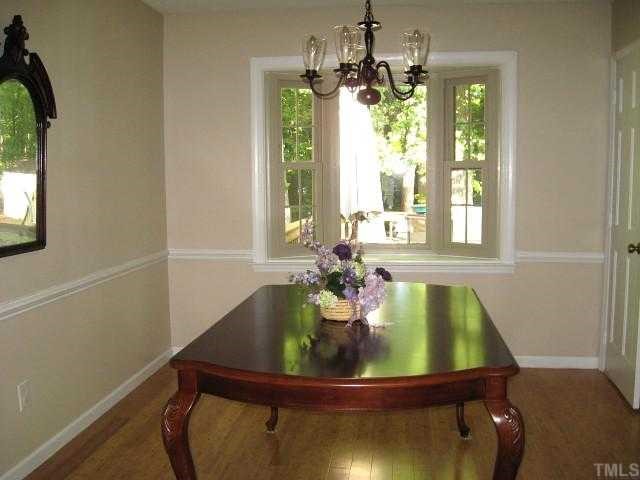 6517 Glendower Road Raleigh, NC 27613 - Photo 3 of 12 Separate dining room with chair rail & new bamboo floor