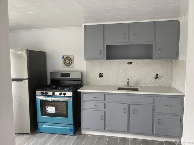a kitchen with stainless steel appliances a stove sink and cabinets