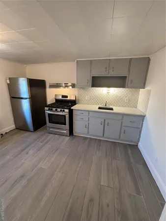 a kitchen with granite countertop a stove and a refrigerator