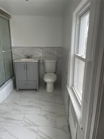 a bathroom with a toilet and a shower