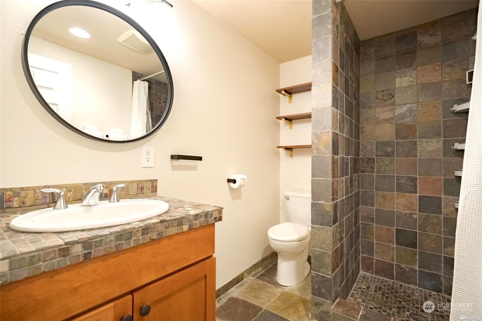 1239 Northwest 119th Street Seattle, WA 98177 - Photo 29 of 36 a bathroom with a sink a toilet and a mirror
