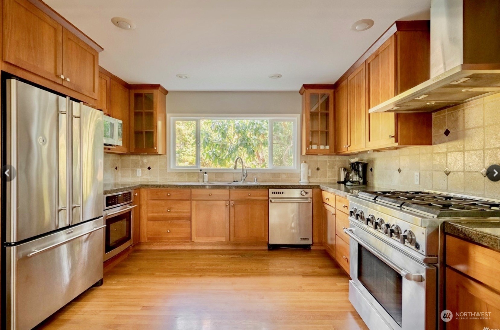 1239 Northwest 119th Street Seattle, WA 98177 - Photo 3 of 36 a kitchen with stainless steel appliances granite countertop a stove a sink and a refrigerator