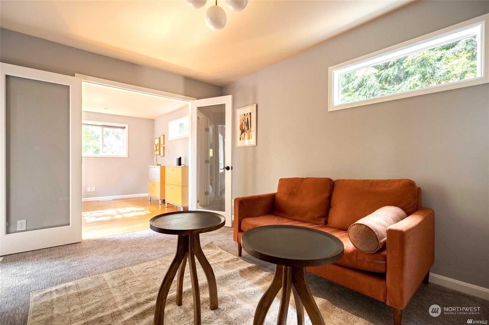 1239 Northwest 119th Street Seattle, WA 98177 - Photo 10 of 36 a blue room with a couch and a table