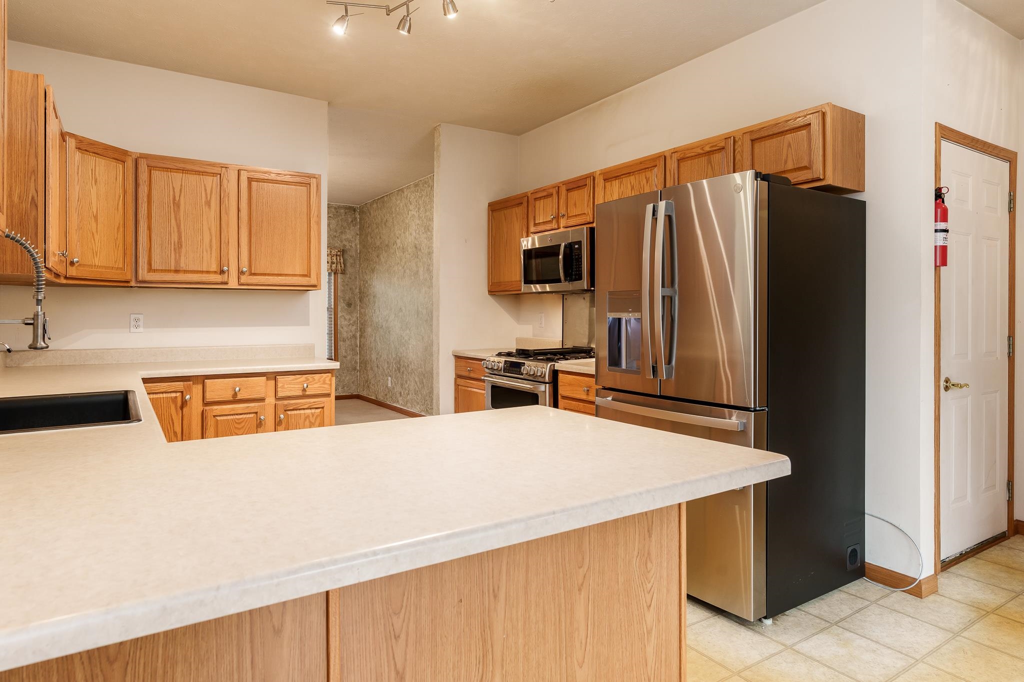 5166 East Hubbard Trail Byron, IL 61010 - Photo 17 of 42 a kitchen with stainless steel appliances a refrigerator and a sink
