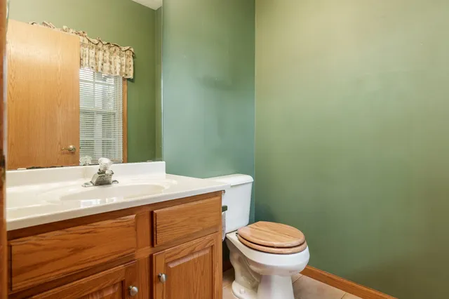 an empty room with a fireplace and windows