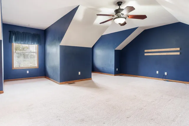 a view of an empty room with a ceiling fan
