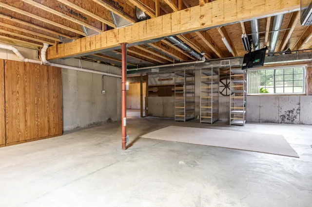 a view of an empty room with storage and utility