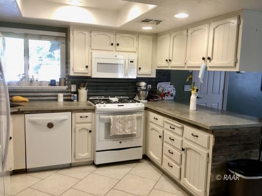 509 South Appaloosa Street Ridgecrest, CA 93555 - Photo 5 of 26 a kitchen with granite countertop white cabinets and white appliances