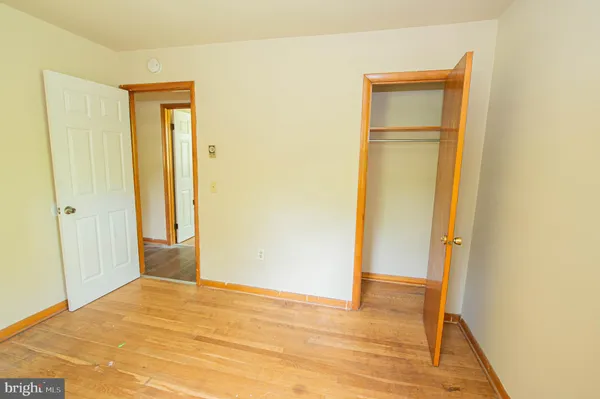 a view of a room with wooden floor and closet