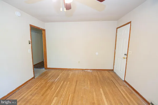 a view of a room with wooden floor and a sink