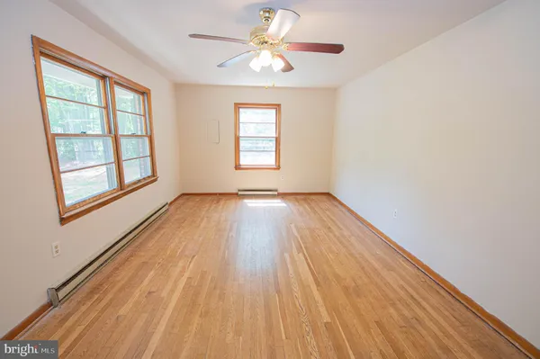 wooden floor in an empty room with a window