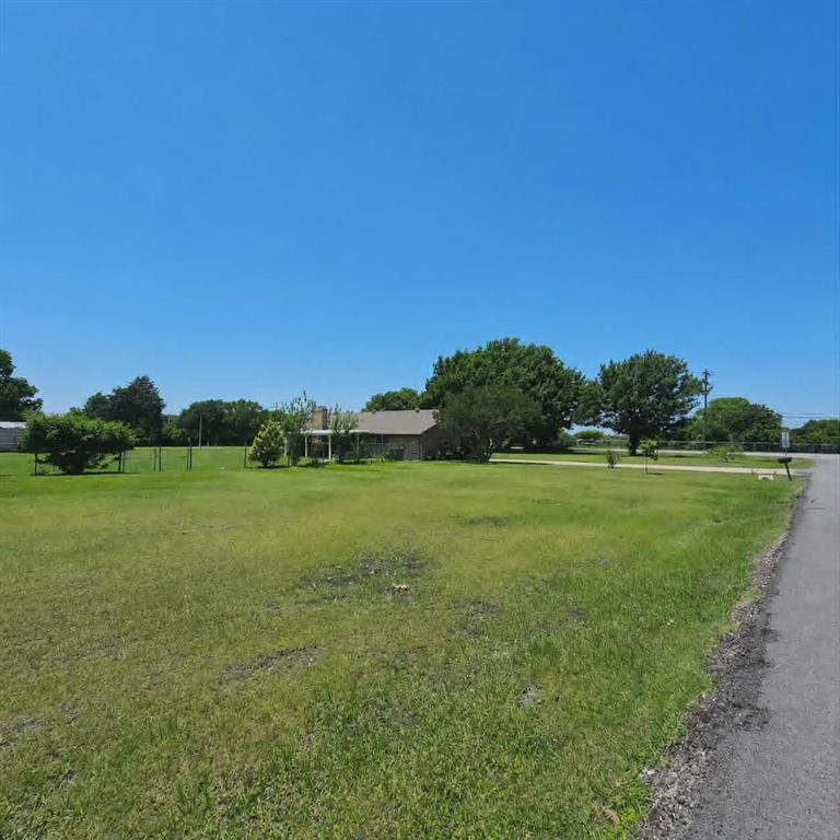 14752 Ranch Road Forney, TX 75126 - Photo 38 of 40 Expansive green lawn with a single-story residence featuring a covered porch with white columns