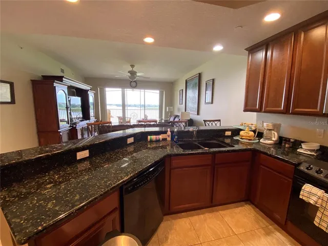 a view of a a dining room with furniture and chandelier