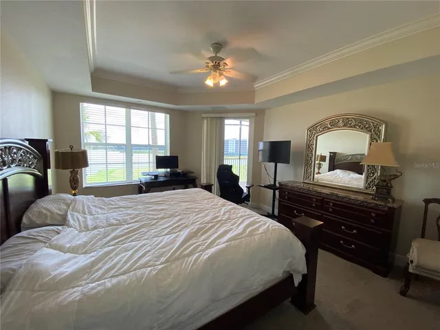 a bedroom with a bed and a dresser with the mirror