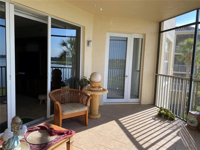 a living room with furniture kitchen view and a chandelier